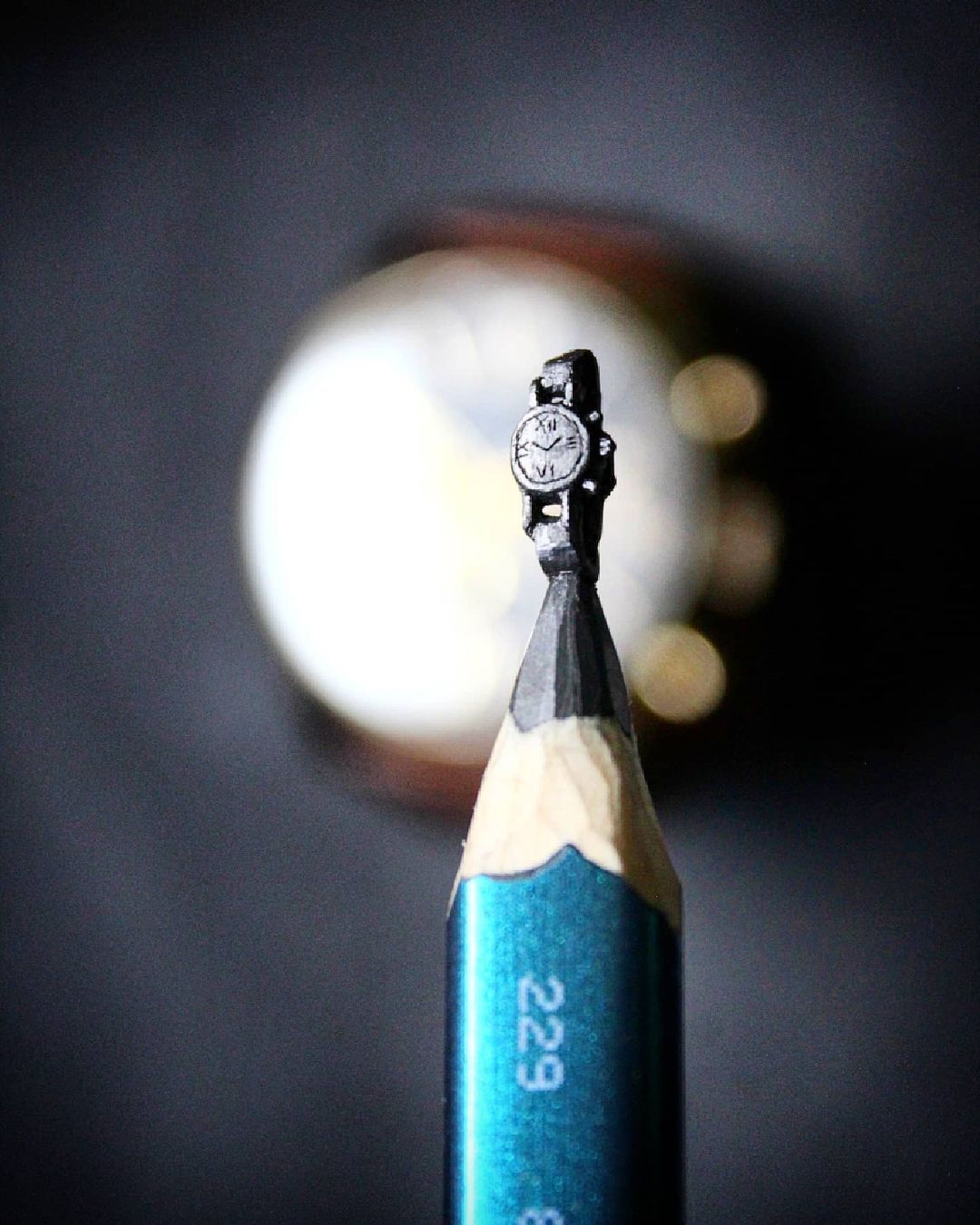Watch carved on pencil tip, microsculpture by Yuvraj Singh Nain